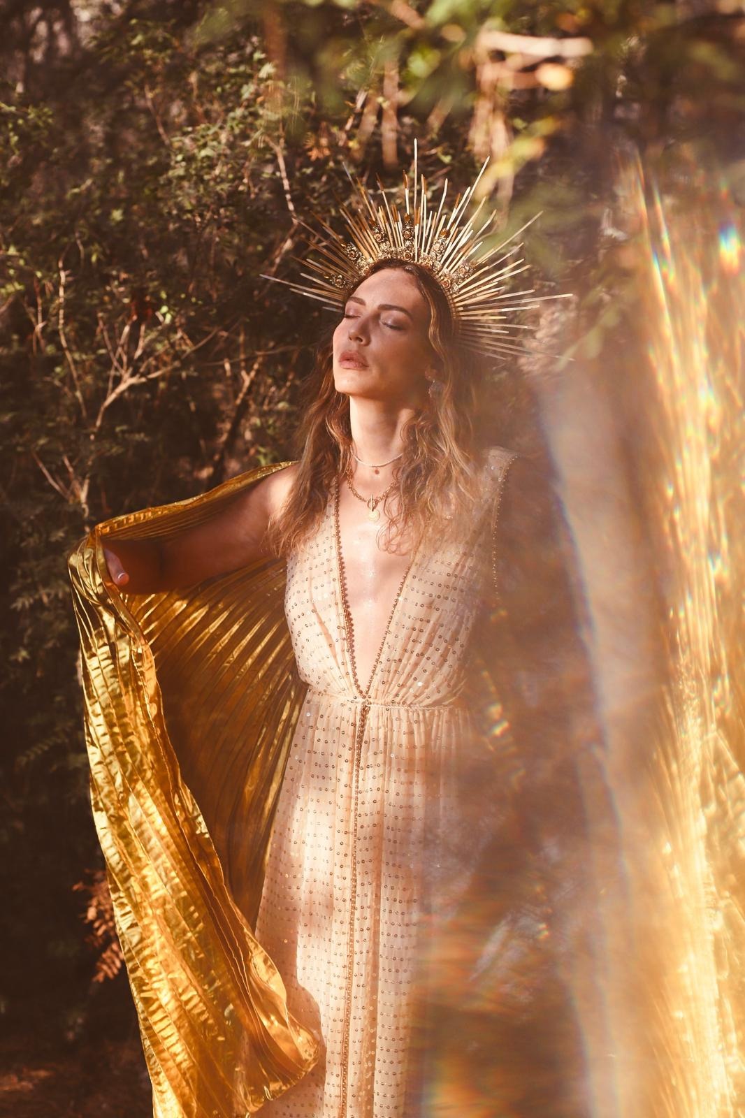 Woman in gold light among the trees